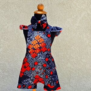 Criss Cross nav blue/orange floral romper with ruffle straps. Hair bow included